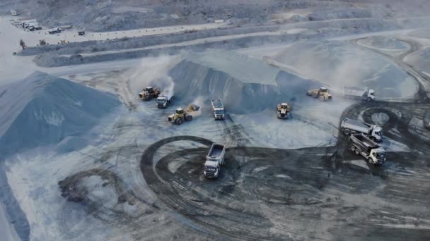 AERIAL. Top angle view of big career and excavators pours sand into the truck. On the construction site top view. Shooting from the drone. — Stock Video