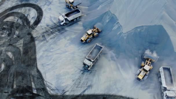 AERIAL. Top angle view of big career and excavators pours sand into the truck. On the construction site top view. Shooting from the drone. — Stock Video