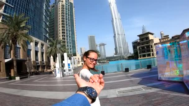 Viaggio di lusso donna che tiene la mano del marito che la segue, vista da dietro. Donna guardando la vista sulla famosa destinazione di viaggio di Dubai . — Video Stock