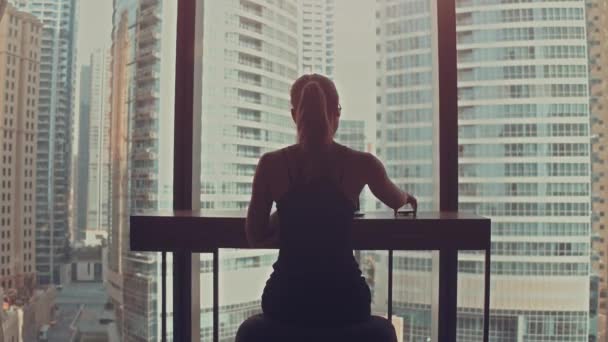 Beautiful Successful Businesswoman Working on a Laptop in Her Office with Cityscape View Window. Strong Independend Female CEO Runs Business Company. Sun Flares Behind Her. — Stock Video