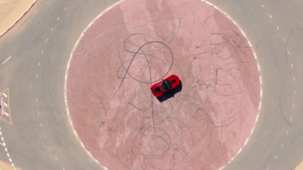 Aerial view Red race car riding on the desert road in UAE. — Stock Video