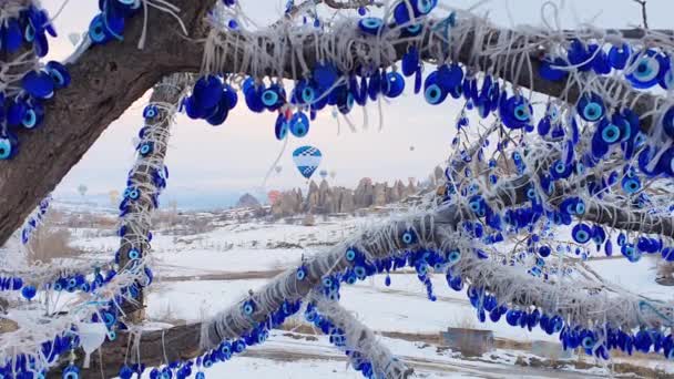 Ett träd med traditionell turkisk souvenir på bakgrunden av flygande varmluftsballonger. Resekoncept efter pandemisk säsong. — Stockvideo