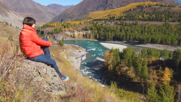 Γυναίκα ταξιδιώτη κοιτάζοντας φυσικό φαράγγι με θέα το βουνό του ποταμού. Έννοια της μετακίνησης — Αρχείο Βίντεο