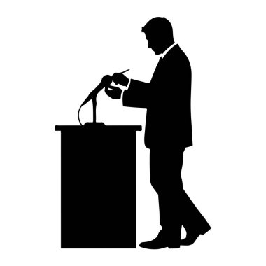 Takım elbiseli bir adamın siyah silueti mikrofonlu bir podyumun arkasında duruyor. O öne eğiliyor, bir kalem tutuyor ve podyumda bir şey yazıyor ya da ayarlıyor gibi görünüyor. Arkaplan düz beyaz.