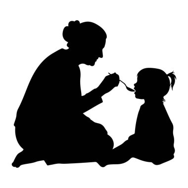 A black silhouette depicts a woman kneeling and feeding a young child with a spoon. The child is sitting and facing the woman, with their mouth open to receive the food. The woman has her hair styled in a bun. The scene is rendered in a simple, graph