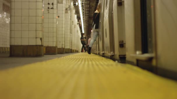 Slow motion of people walking into train at subway station — Stock Video