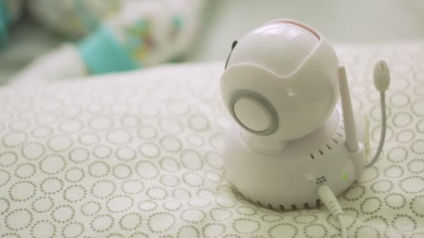 Close-up of baby monitor and slow motion of baby in bed — Stock Video