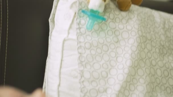 Tiro de uma chupeta de bebê e um bebê na cama — Vídeo de Stock