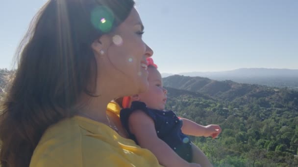 Slow motion of mother showing baby beautiful view of mountains — Stock Video