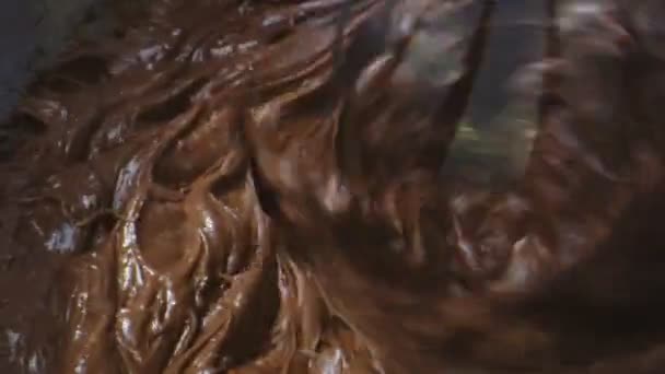 Macro shot of chocolate cake ingredients being mixed in food mixer — Stock Video