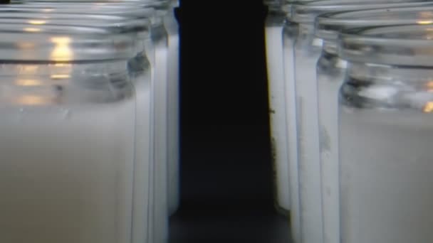 Macro shot moving through row of white candles — Stock Video