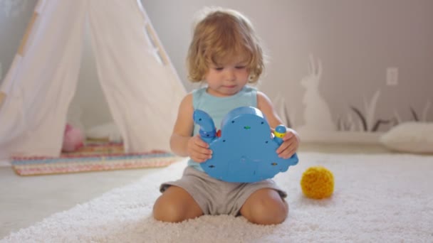 Mooi klein meisje spelen en schudden speelgoed in haar kamer — Stockvideo