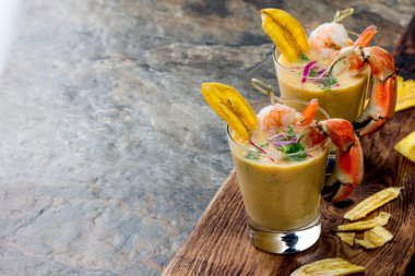 Perulu seviche Leche De Tigre. Çiğ balık kokteyl ceviche kireç, kıyma, biber ve Salantro ile. Geleneksel Perulu Gıda dekore edilmiş yengeçler, srimps ve muz fiş.