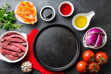 Perulu çanak Lomo saltado - bonfile biftek, sarı biber, domates, soğan, yağ, soya sosu, sirke, garlik siyah plaka etrafında yemek için Ingredientes