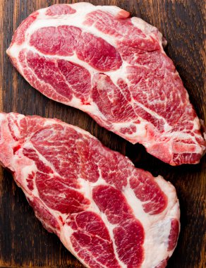 İçin ham pirzola pirzola otlar üzerinde ahşap masa, arduvaz arka plan, üstten görünüm ile barbekü ızgara, alanlarda Kopyala.