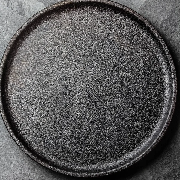 Food background. Empty cast iron black plate. Copy space
