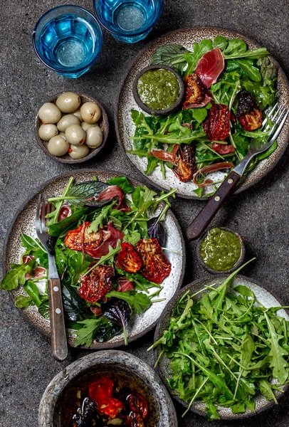 Salada com arugula, espinafre, tomate seco e presunto serrano paleta iberica. Receita keto de carboidratos baixos — Fotografia de Stock
