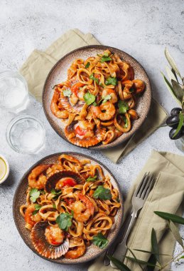 Deniz kabuklu deniz ürünleri spagettisi, karides, gri arka planda mürekkep balığı. İtalyan Akdeniz Gıda Konsepti