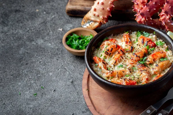 Chilean food. Baked crabmeat crab meat with cheese, cream and bread. Pastel o chupe de sentolla or king crab