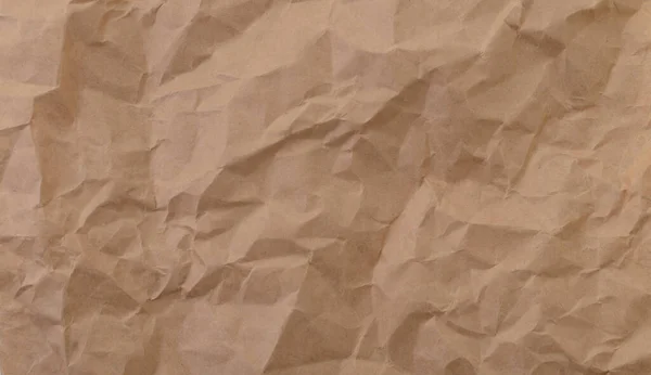 Coarse wrinkled paper. The texture is paper. Brown color.