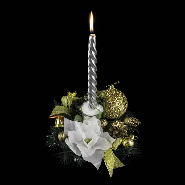 Handmade festive decoration, white flowers, a yellow bell, a yellow ball, branches of a Christmas tree, kidrovymi cones and a burning candle, on a black background — Stock Photo, Image