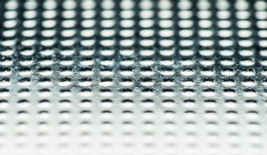 Fosforlu makro, düz saat pilinin kabartmalı dokusu, demir, pezevenk, eski, eski bir bataryanın çizik dokusu.