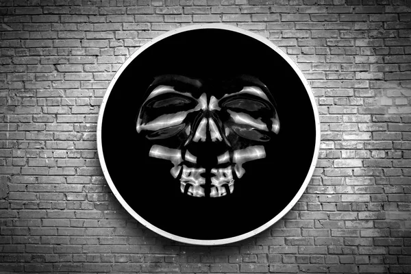 黒の背景の頭蓋骨白い円の中ヴィンテージのレンガの壁にサインとして吊るされた黒と白の写真ハロウィンの背景 — ストック写真