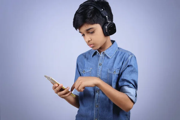 Indian Young Boy Listen Music Headphone Holding Mobilephone —  Fotos de Stock