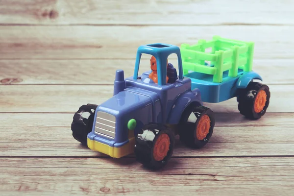 Toy Tractor model with the trailer on a white background