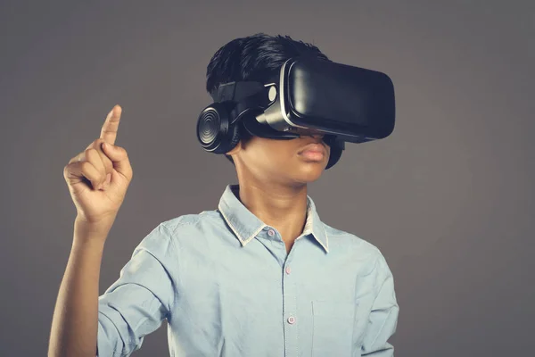 Portrait of Indian young boy wearing Virtual Reality Glasses