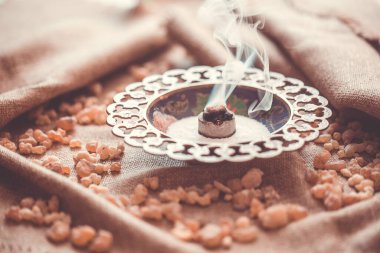 Sıcak kömürde tütsü yanıyor. Tütsü aromatik reçinedir, dini ayinler, tütsü ve parfümlerdir, tütsü dumanıdır.