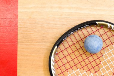 Close up of a squash racket and ball on the wooden background, sport concept clipart
