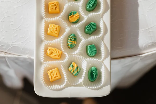 Yellow and green candy in the mold are on the table, top view — Stock Photo, Image