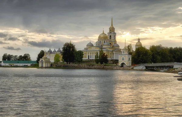 Пейзаж озера Селигер с видом на монастырь Ниловы Пустыни. Остров Столбный. Вечером солнце приближается к закату. Небо покрыто облаками . — стоковое фото