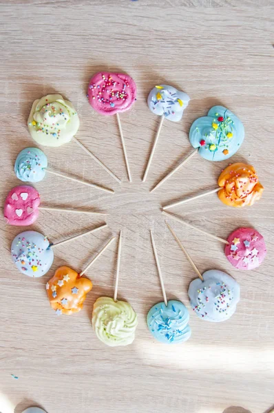 Ferris wheel of clock roung shape of meringue. french meringue on candy stick. confectionary and cafe. master class on decoration. geometry shape study with kids. mock up dessert background.