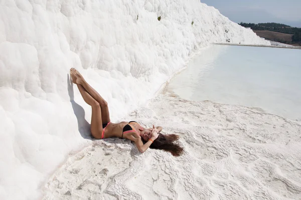 Sexy woman with fit suntan body. Natural travertine in Pamukkale. Beach life. Cotton castle in southwestern Turkey. Summer vacation in Pamukkale. Dead sea salty shore. Sexy girl. Stylish and sexy.
