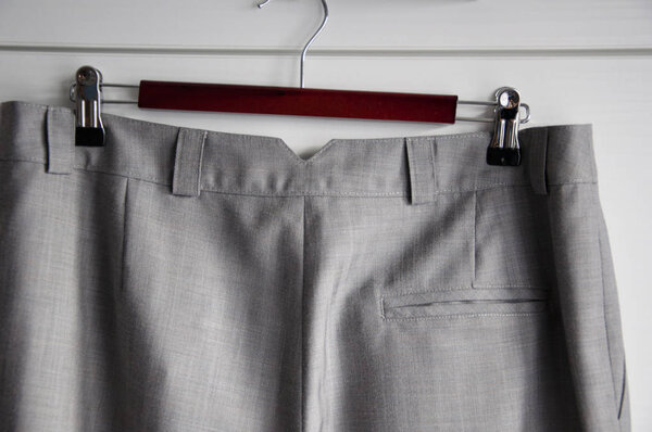 beautiful textile fabric or cloth grey color as fashionable background, closeup. part of female pants with pocket and belt loops
