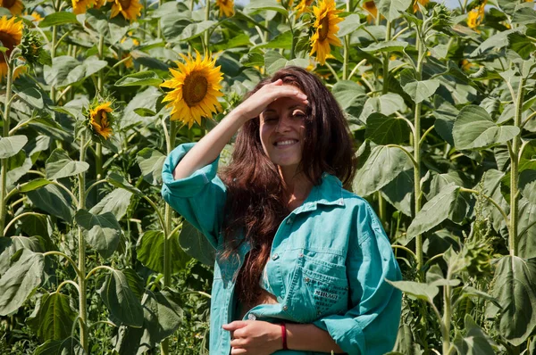 Close to nature. Summer concept. smiles beautiful smile. woman standing in sunflower field. Sexy sensual portrait of girl in ranch shirt. sexy sensual girl with nice smile. fashion model in field.