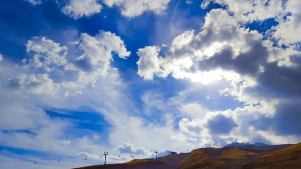 A horizontal shot of bright blue sky with puffy white clouds. 27 September, 2015.