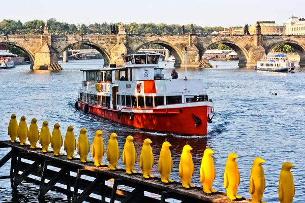 Red boat near Yellow Penguins in Prague