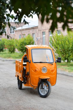 Turuncu elektrik kargo tuk tuk parkta