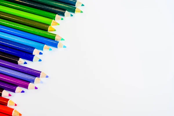 Line of color pencils isolated on white background. Close up. Copy Space. — Stock Photo, Image