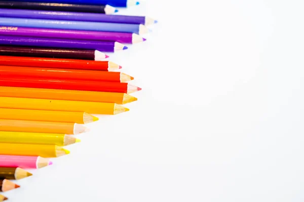 Line of color pencils isolated on white background. Close up. Copy Space. — Stock Photo, Image