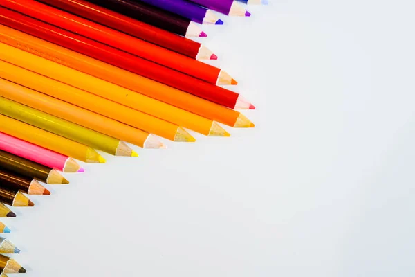 Line of color pencils isolated on white background. Close up. Copy Space. — Stock Photo, Image