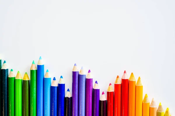 Line of color pencils isolated on white background. Close up. Copy Space. — Stock Photo, Image