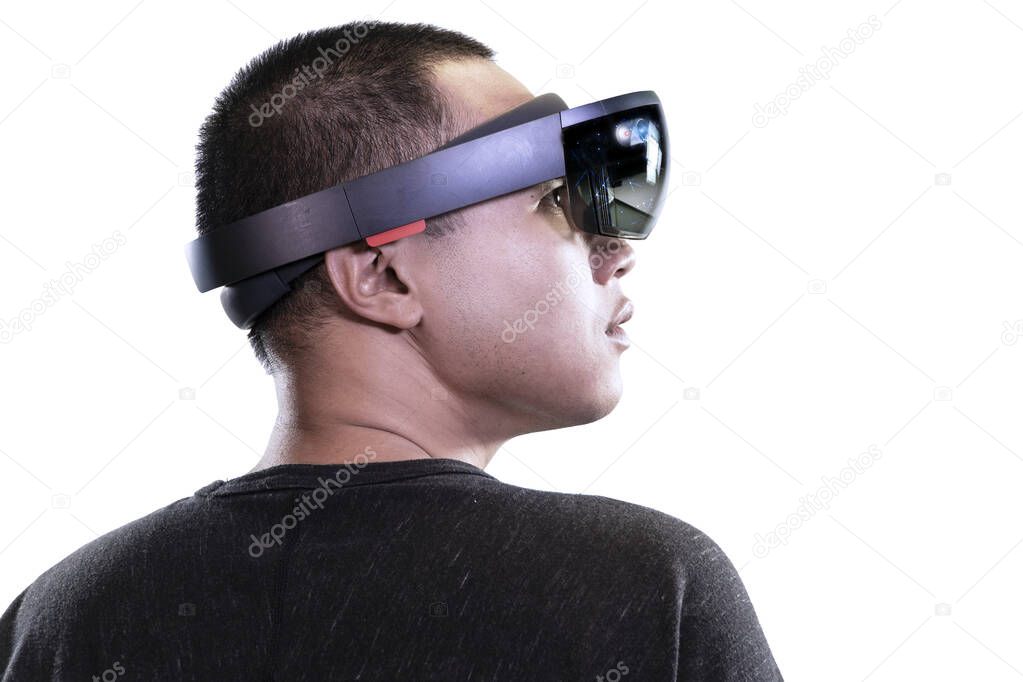 Portrait of man try Mixed reality with HoloLens glasses isolated on white background. Future Technology concept