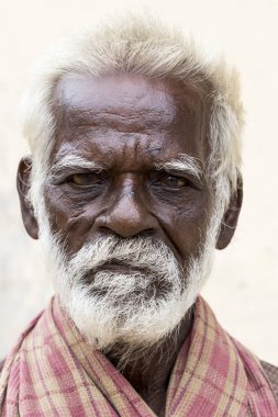 Pondichery, Puducherry, Tamil Nadu, Hindistan - Eylül yaklaşık, 2017. Bir unidentifed eski üst düzey Hint fakir adam portre bir koyu kahverengi buruşuk yüz ve beyaz saçlı ve Beyaz sakalı, ciddi ya da üzgün görünüyor