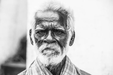 Pondichery, Puducherry, Tamil Nadu, Hindistan - Eylül yaklaşık, 2017. Bir unidentifed eski üst düzey Hint fakir adam portre bir koyu kahverengi buruşuk yüz ve beyaz saçlı ve Beyaz sakalı, ciddi ya da üzgün görünüyor. Siyah ve beyaz