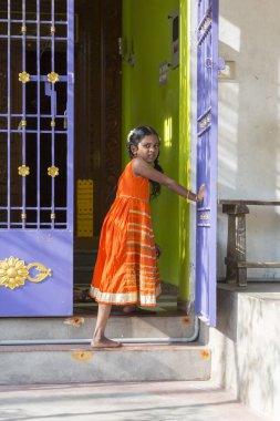 PONDICHERY, PUDUCHERRY, TAMIL NADU, INDIA - SEPTEMBER Circa, 2017. An unidentified poor girl in a small village, outdoor, looking at the camera clipart