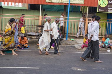 RAMESHWARAM, TAMIL NADU, INDIA- MARCH CIRCA 2018. In the main street, Unidentified Hindu pilgrims people ready to go to the temple by walking, after the bath at the gate. Great time for all the families clipart